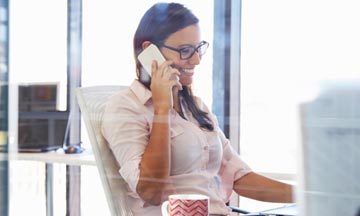 Business woman records a conference call on her mobile phone